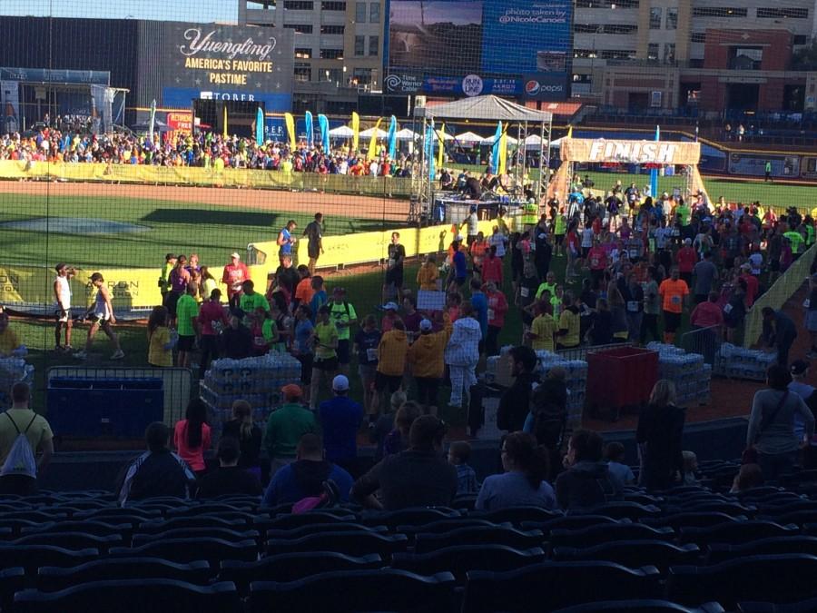 Runners cross the finish line at Canal Park, home of the Rubber Ducks