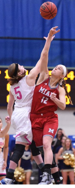 Kerri McMahan does a jump ball with Miami player.