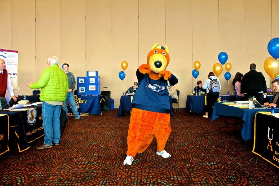 While students meander about and get information at the Majors Fair, Zippy encourages them to study what they love. 