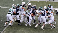 Conor Hundley (middle with ball) fights for more yards earlier this season