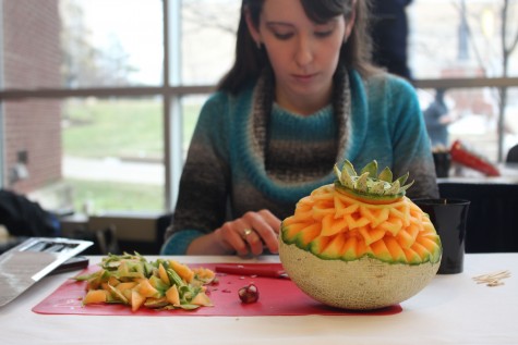 Elizabeth Connolly, a junior speech pathology major, carves a cantaloupe. 