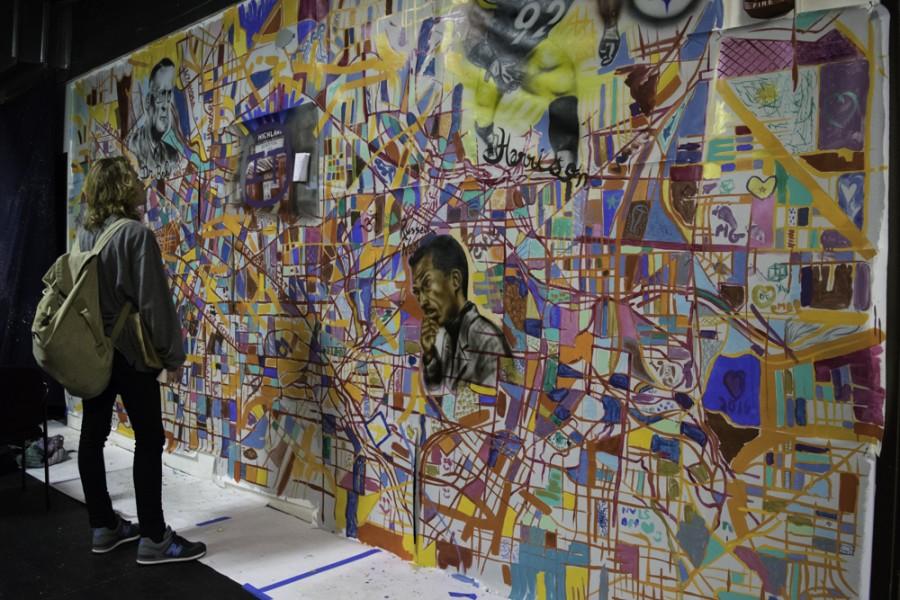 UA student Ben Holda, a sophomore, admires an artistic rendition of a map of Akron at Big Love Fest.