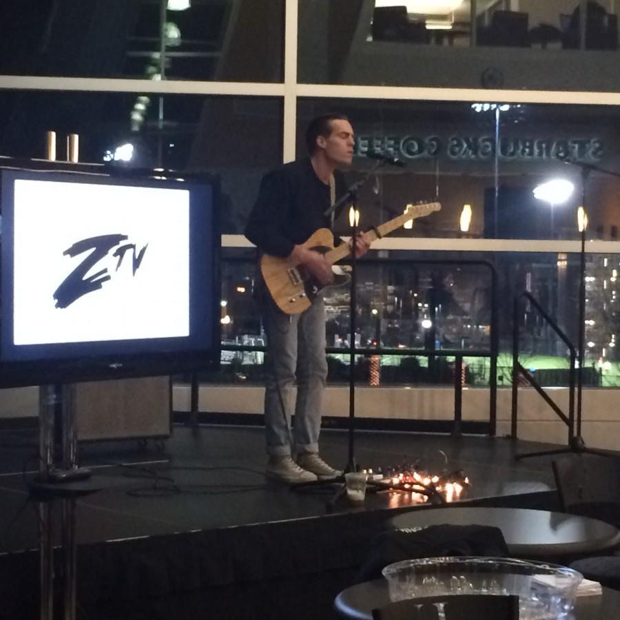 Student Paul Clifford performs songs while playing guitar in the Starbucks Lounge. 