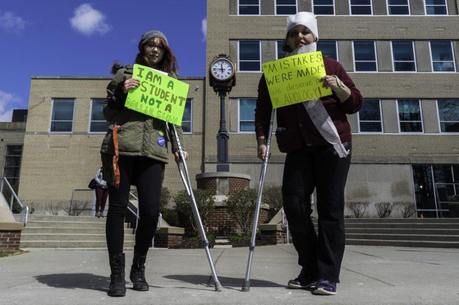 Two "wounded" students, Angelica Corrado and Kasey Serrano, protesting against University leadership outside the Student Union on Tuesday, a day before the Board meeting. 