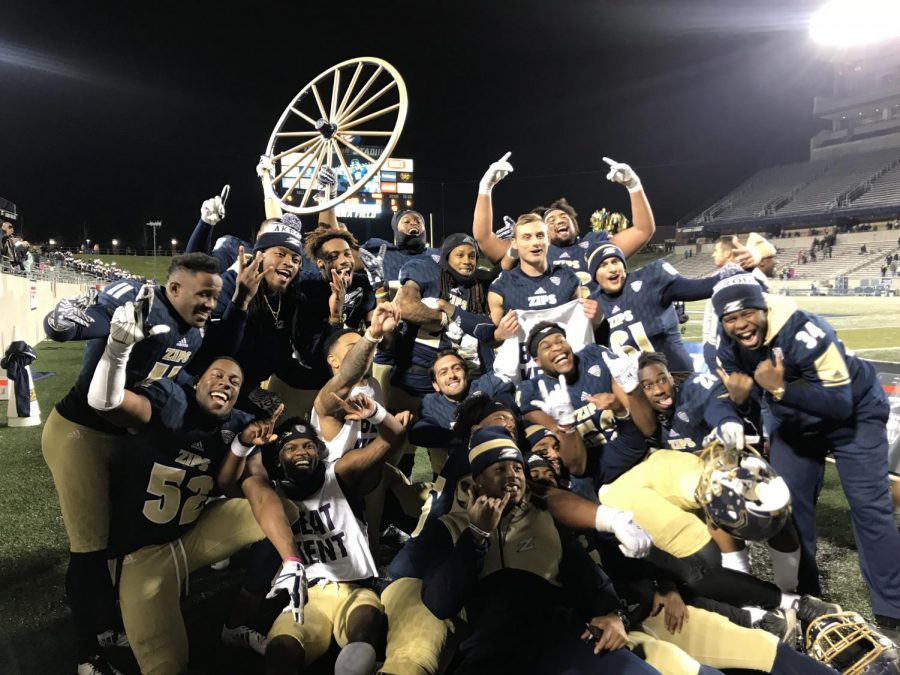 Members+of+the+Akron+Zips+football+team+celebrate+with+the+Wagon+Wheel+following+their+24-14+win+over+Kent+State+at+InfoCision+Stadium+on+Tuesday.