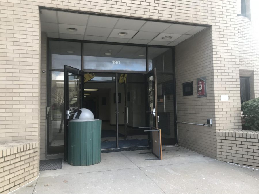 Random articles of furniture and wet floor signs are quickly fashioned to prop open the entrance to the Knight Chemical Laboratory during an evacuation following a fire on the first floor.
