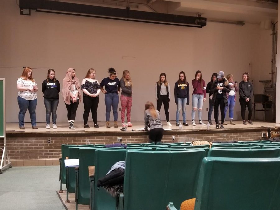 Music Director Lauren Spape, center, teaches members of Kanga Blue the choreography for each song.