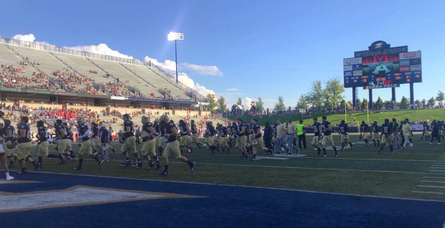 The Zips exit the field as the weekend's homecoming festivities take place during halftime.