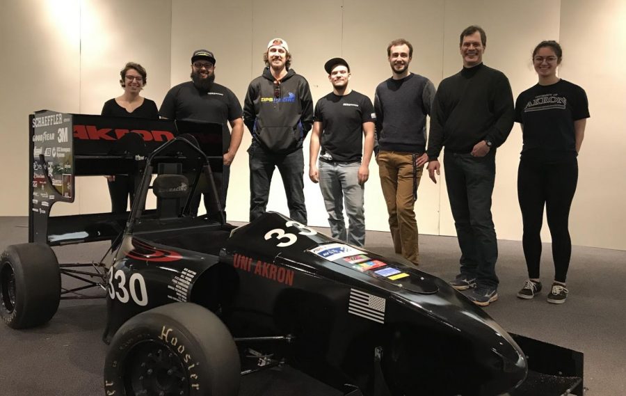 Members of Zips Racing with the 2017 model race car that will be on display at the entrance of the Great Lakes Science Center’s Vroom! A Car Adventure exhibit where visitors can get in the driver’s seat for a photo. Team members are (from left)  Maria Hatzis, team captain Ezra Malernee, Jacob Greer, Clayton Brown, David McVan, faculty advisor Dr. Daniel Deckler, Ph.D. and Sidney Mingle.