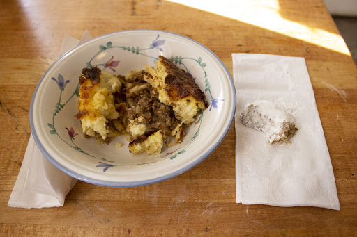 A bowl of Pastitsio and a Greek Almond Wedding Cookie from Western Fruit Basket.