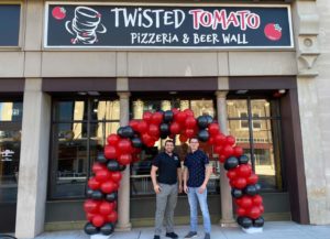 Chris Sedlock (L) and Brad Cover (r) celebrate the Twisted Tomato Pizzeria & Beer Wall opening.