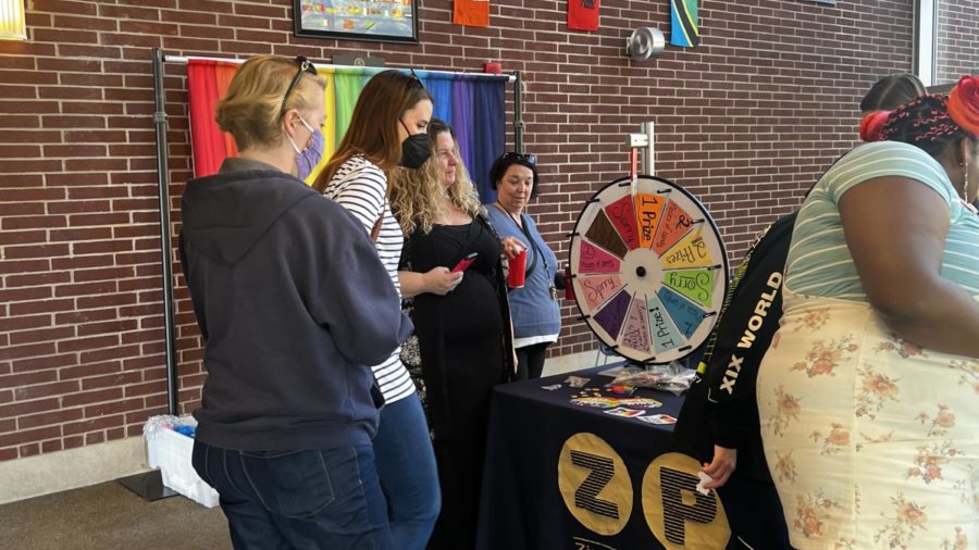 Students standing in front of a Prize wheel.