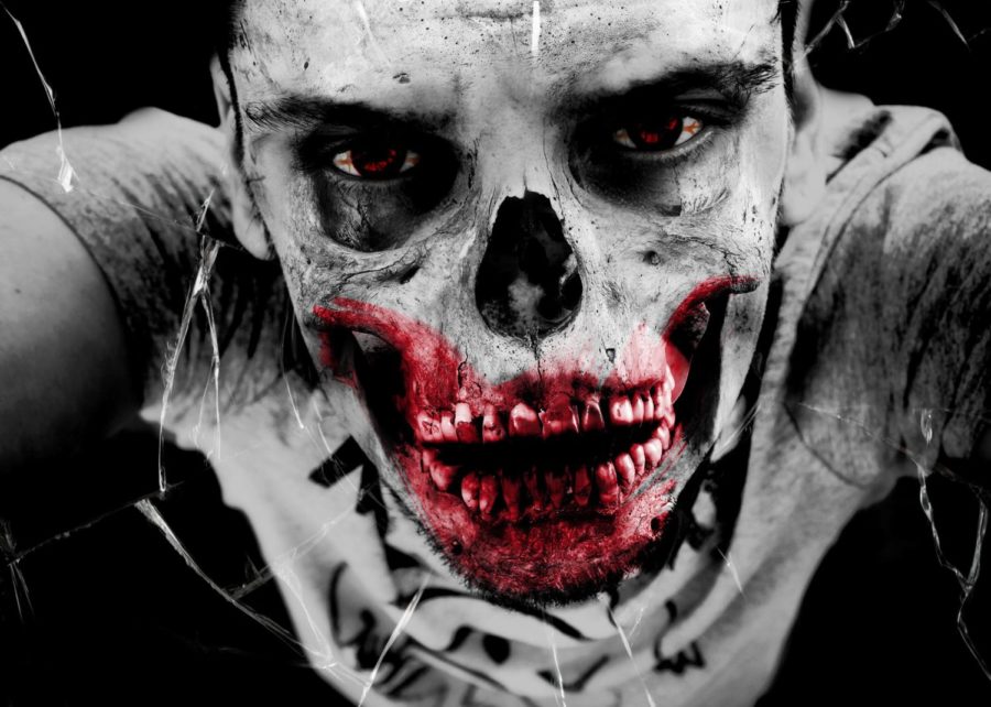 An up close image of a zombie with skeleton teeth and blood.