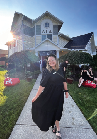 Natalie Mowad standing in front of Alpha Gamma Delta sorority house at The University of Akron 