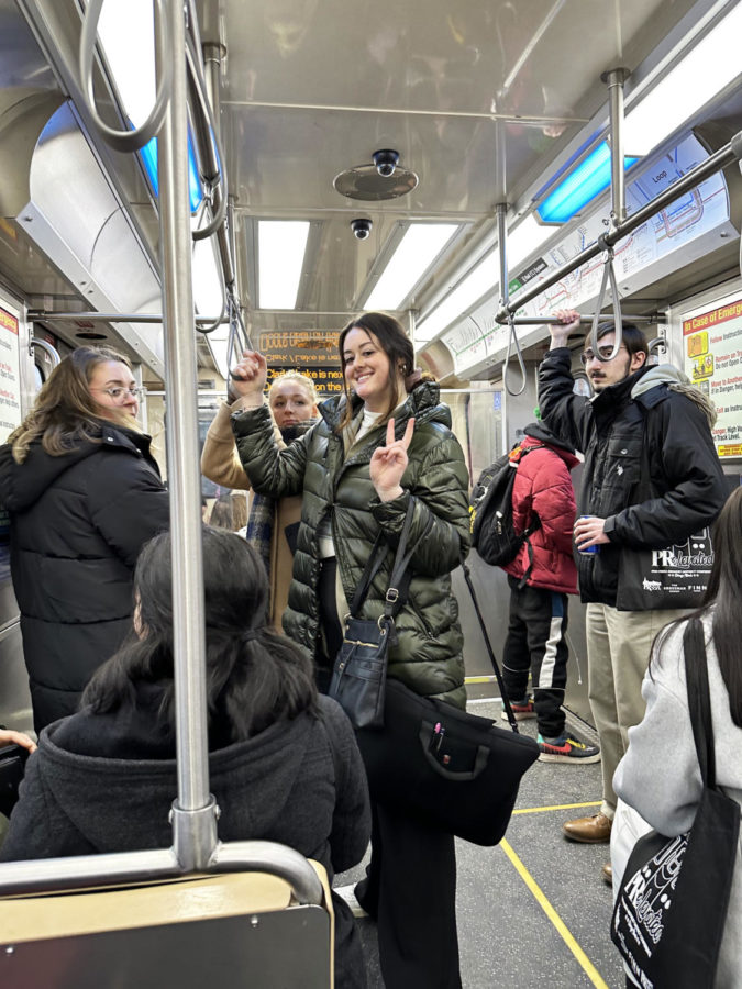 Alexa with a group of friends on the L-train in Chicago during the PRSSA trip to attend the regional conference at DePaul University.