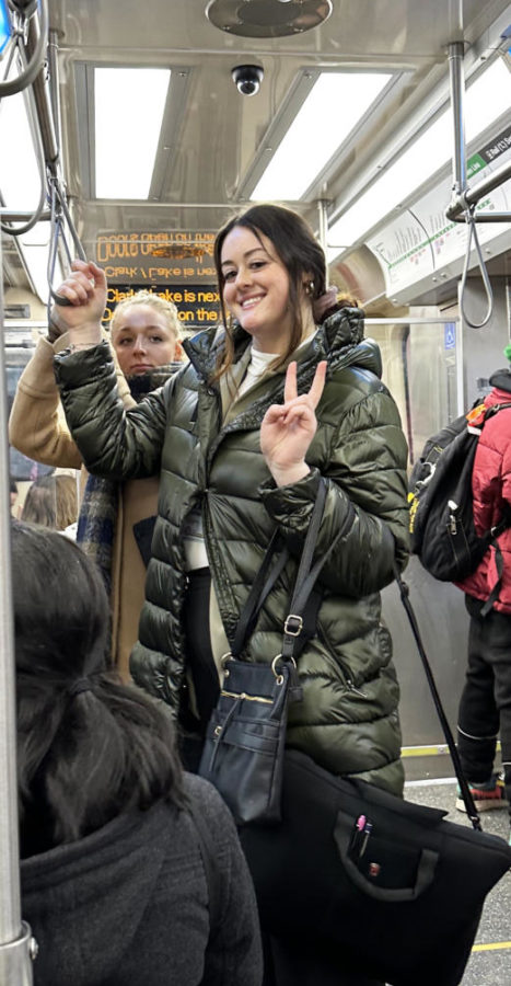 Alexa Baumberger standing on the L-Train with a group of students.