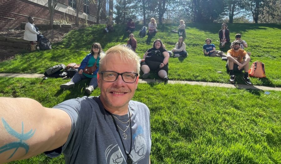 Scott Kenimond, scholarship winner takes a selfie during a class meeting outside.